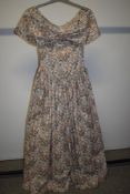 A vintage floral gown having statement neckline, possibly Laura Ashley fabric.