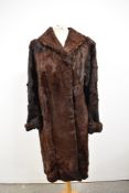 A vintage full length 1940s fur coat, having contrasting Astrakhan edge to collar and cuffs.