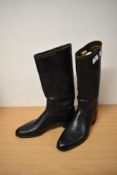 A pair of early 20th century black leather riding boots, having stack heel and Craig and Davies
