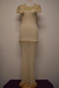 A stunning 1930s bias cut cream crepe nightdress having tulle neckline with champagne coloured crepe