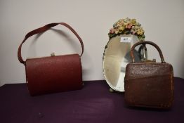A dressing table Barbola mirror, a 1950s red box bag and a 1920s/30s small leather bag with
