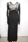 A 1930s bias cut gown having textured crepe or similar skirt and sheer lace bodice with long sleeves