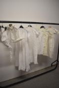 An assortment of Victorian babies clothing including gowns, cape and bonnet, some pretty
