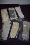 Six pairs of ladies vintage gloves in packaging.