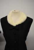 Two early 1960s black dresses, including white mink trimmed evening dress.