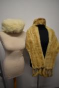 A vintage 1950s blonde mink wrap with tails, sold with a mink hat and a white fox fur hat.