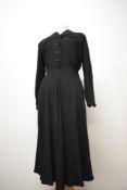 A 1940s black day dress having braided detailing to bodice, buttons to front and side metal zip,