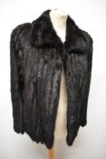 A Saga mink coat in dark brown, interspersed with suede inserts, small to medium size, around late