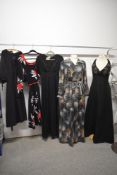 Five 1970s dresses, including black halter neck maxi dress with beadwork to bodice.