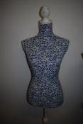 A modern female body form in blue floral design.