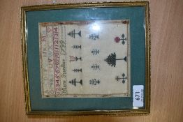 A framed and glazed needlework sampler of small proportions, Mary Standley, 1799, depicting trees,