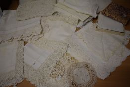 A selection of antique table linen, to include intricate crotched cloths, napkins and more, some