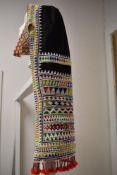 A vintage Bedouin tribal head dress, having extensive glass beading throughout and tassel