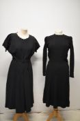A 1930s black textured day dress having press stud fastening to side, neckline and fitted cuffs, and