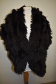 A stunning 1920s/30s ostrich feather stole with button fastening to front.