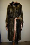 A 1920s lame dress of gold and silver on black ground, having draped sleeves with large statement