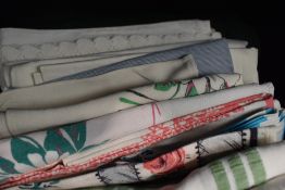 A miscellany of textiles to include mid century aprons, A pyjama case, brightly printed mid