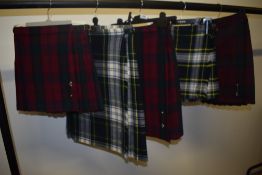Five vintage girls kilts, various tartans and sizes.