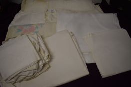 A collection of vintage and antique Damask table cloth and napkins.