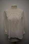 An Edwardian white cotton blouse with pin tuck to front and lace to upper bodice with crotchet