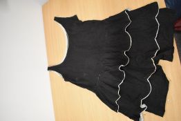 A scarce early 20th century ladies black and white skirted swim suit with button fastening to tops