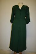 A bottle green 1930s crepe de chine dress having beaded accents and faux self covered buttons to