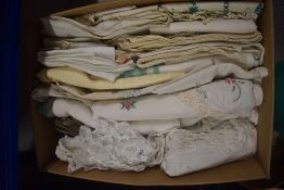 A box full of vintage and antique table linen including embroidered examples, tray and table