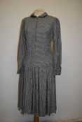 A late 1930s dog tooth day dress, having dropped waist, peter pan collar, pleated skirt, side