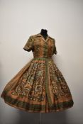 A 1950s Betty Barclay silk dress with Paisley pattern in autumnal tones, having buttons to front and