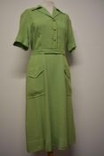 A 1940s lime green CC41 utility labelled linen day dress having turn up cuffs, side metal zip,
