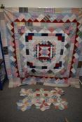 An early 20th century un backed patchwork quilt and a smaller unfinished section, both are lovely