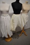 Three pairs of Victorian and Edwardian bloomers, including button back and lace edged knickers