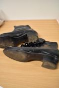 A pair of Edwardian black leather button fastening ankle boots.