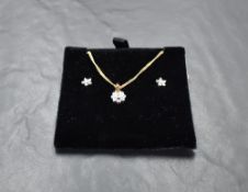 A 9ct diamond-set white and yellow gold necklace and earring set, each of stylised flower head