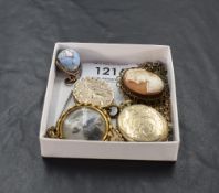 A selection of rolled gold vintage jewellery including lockets, globe charm, chain, cameo brooch