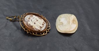 A conch shell cameo brooch depicting the three graces in an open decorative yellow metal brooch
