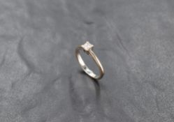 A princess cut diamond solitaire ring, approx 0.33ct in a 4 claw mount on an 18ct white gold loop,