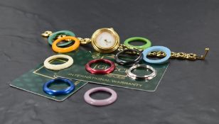 A ladies gold plated Gucci bracelet watch having ten multi coloured interchangeable bezels and