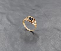A William IV 18ct gold gent's mourning ring having black panel and enamelled decoration to shaped