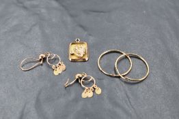 A small group of yellow metal jewellery, comprising two pairs of earrings, and scorpio pendant, some