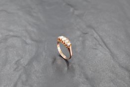 A five stone graduated opal ring in a clawed gallery mount on a 9ct rose gold loop, size O/P &