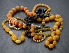Five strings of beads including amber style, simulated pearl with gold clasp and jet style