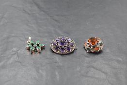 A white metal amethyst and marcasite set brooch, of oval form set with nine oval-cut amethyst stones