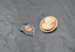 A conch shell cameo brooch depicting a maiden in profile in a decorative 9ct gold mount and a silver