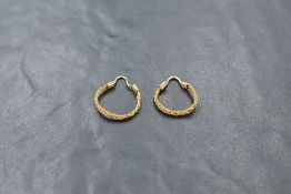A pair of attractive two-tone yellow metal hoop earrings, unmarked, 1.5grams gross.