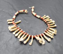 An African animal tooth and bead necklace 34cm