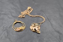 A 9ct two coloured gold pendant having foliate detail on a 9ct rose gold chain, approx 20' chain and