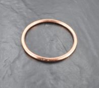 A 1920's 9ct rose gold slave bangle of plain hollow tubular form, approx 83mm diameter & 12.6g
