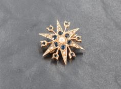 A 9ct gold sapphire and seed pearl set star brooch, marked 375 to reverse, 2.5cm, 3.5grams