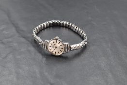 A lady's Omega Geneve wrist watch having baton numeral dial to silvered face in a steel case on a